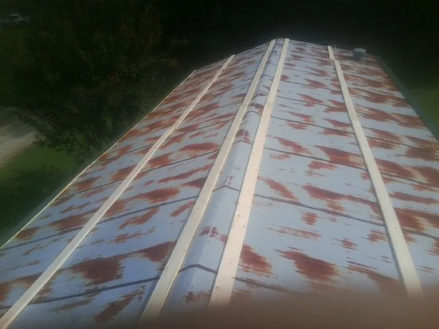 Rusted metal roof panels with new wood purlins before replacement — Storm Damage Roof Repair in Mays by Roofing Brothers